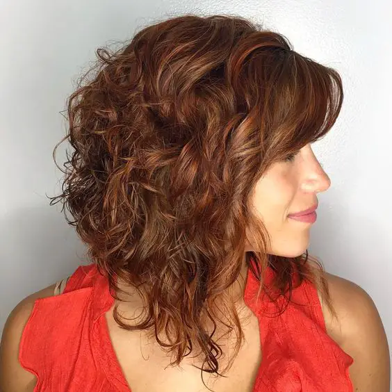 34 Cute Short Hairstyles for Women with Curly Hair (Must Try in 2022) Curly-inverted-layered-bob-2
