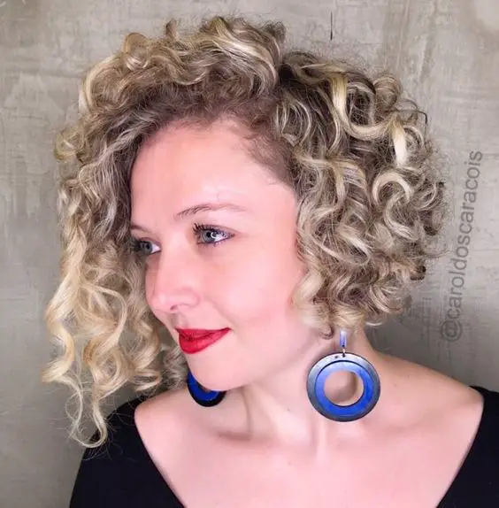 60 Best Short Curly Hairstyles for Women Over 60 in 2022 Shaggy-angled-curly-bob
