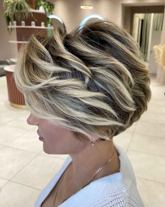 23 Excellent Short and Sassy Haircuts for Women Over 60 (Updated 2022) 23.-Voluminous-wedge-haircut-with-blonde-highlights