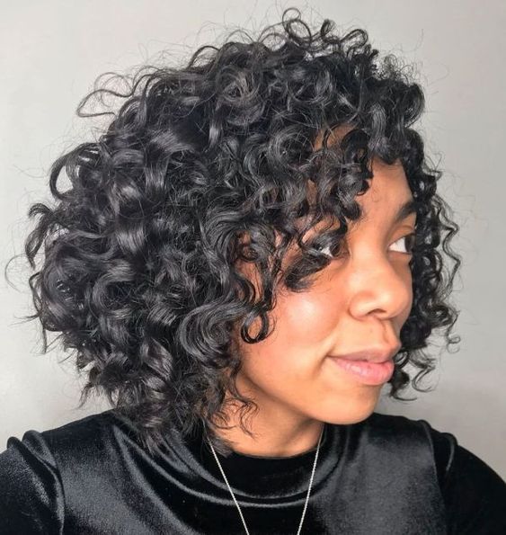 Gorgeous Short Hairstyles for Black Women (Update 2022) Chin-Length-Curly-Angled-Bob