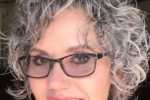 Cute Curly Hairstyle For Over 60 Women With Glasses And Grey Hair